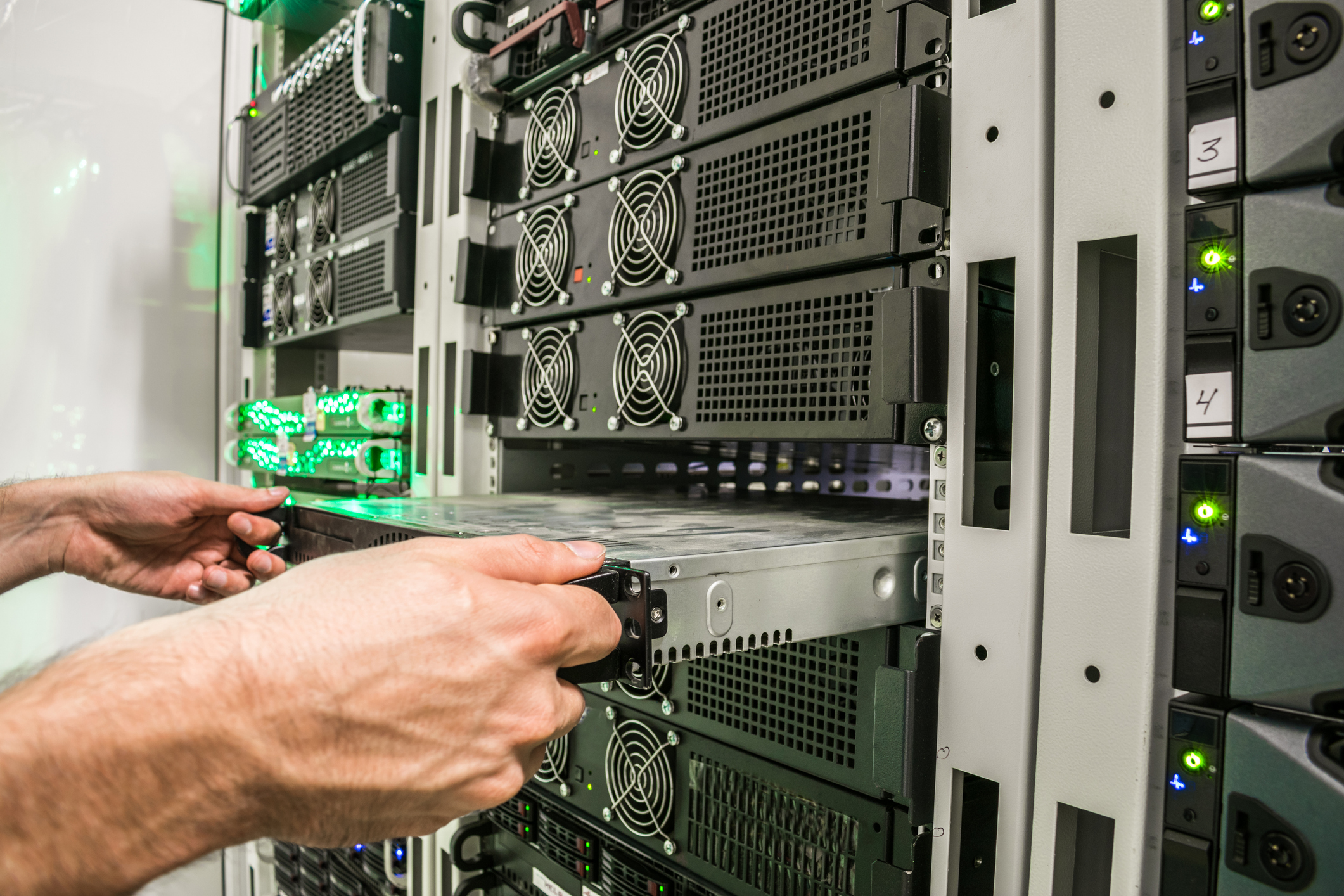Installing a new server in the server datacenter rack. Repair of powerful Internet equipment. Engineering work in the server room is the data center.